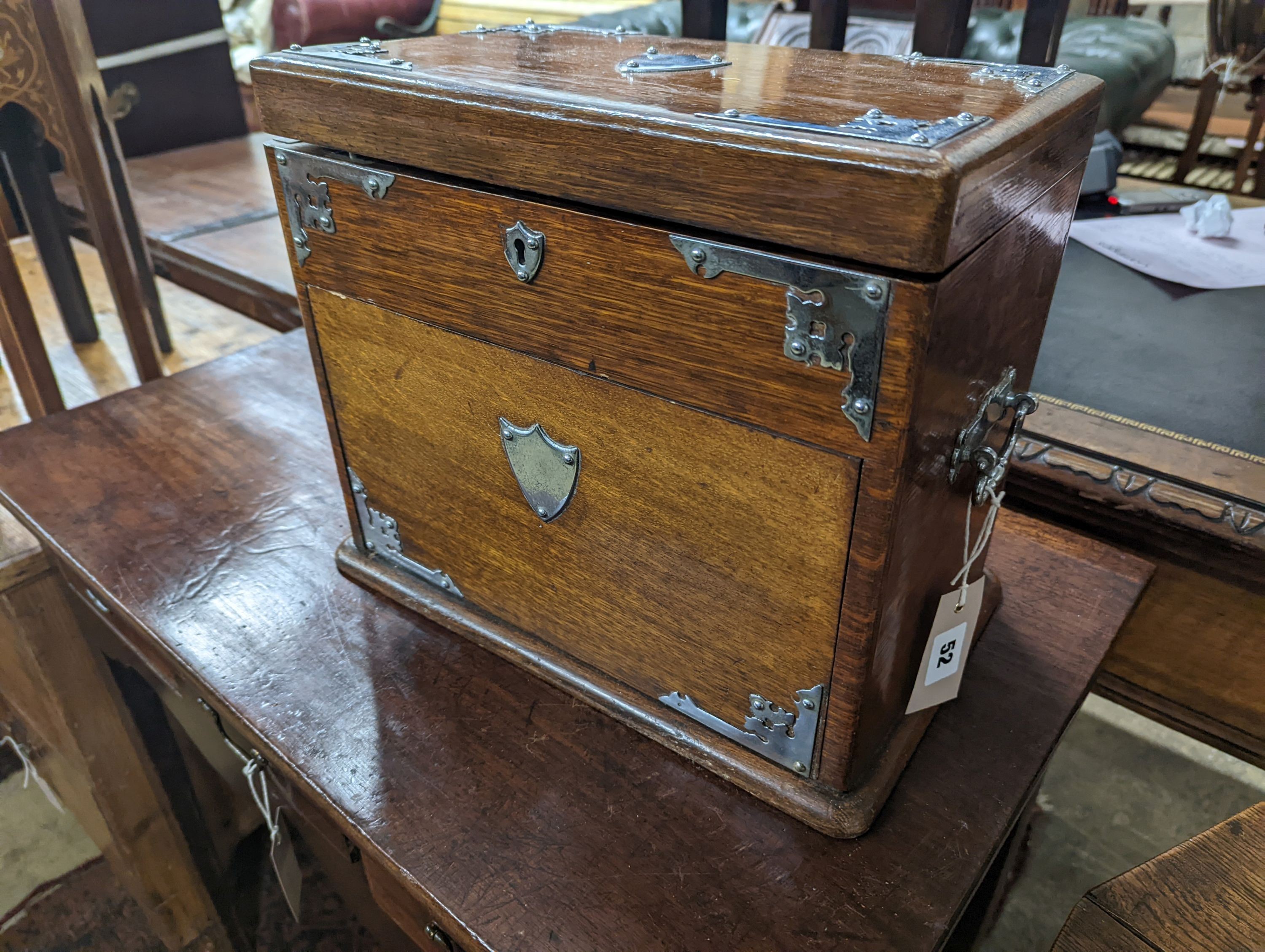 A late Victorian metal mounted oak smoker's box, width 34cm, depth 20cm, height 29cm